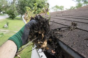 Man is cleaning roof